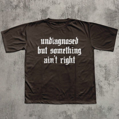 Brown t-shirt with white text on a textured gray background