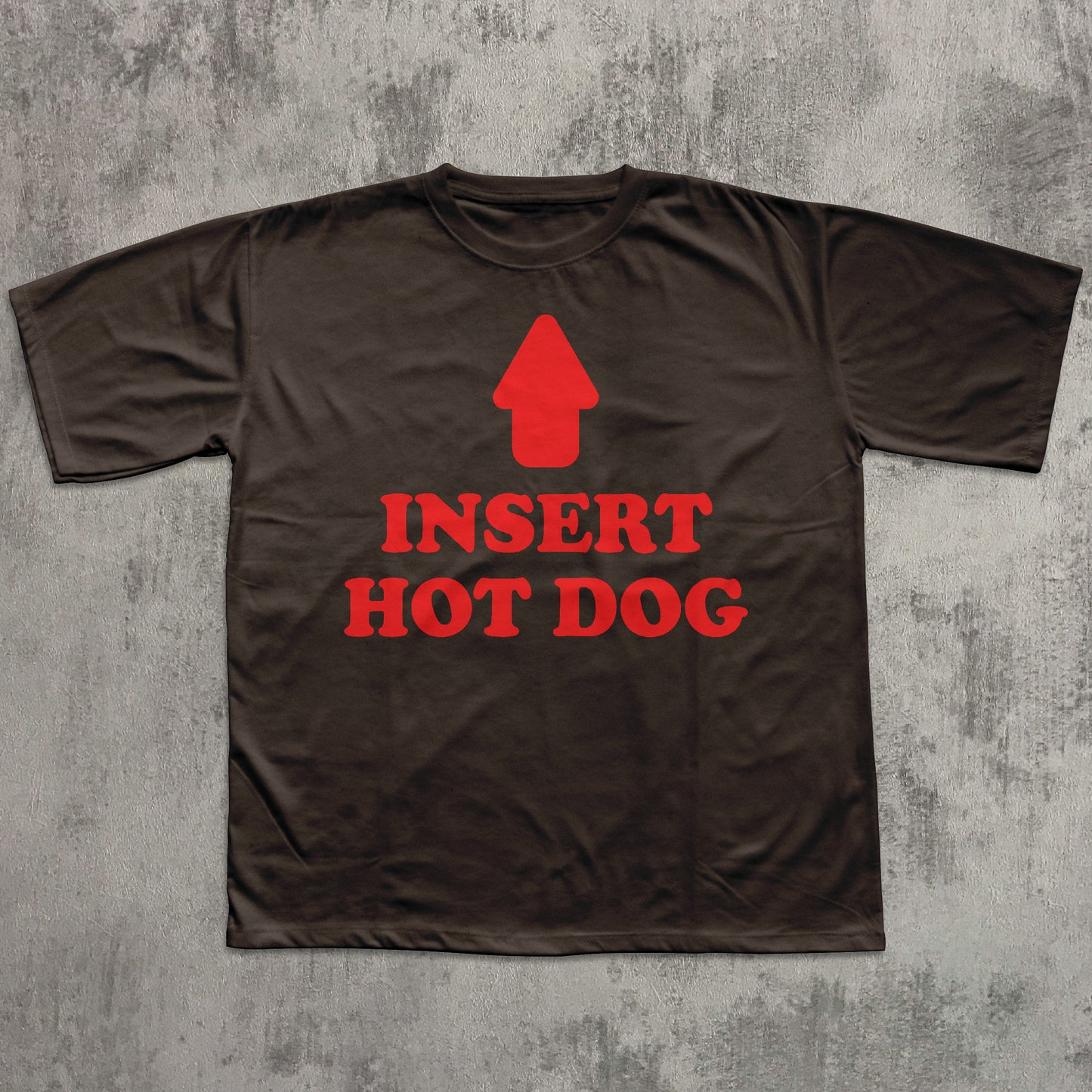 Brown t-shirt with red graphic and text 'INSERT HOT DOG' on a textured gray background