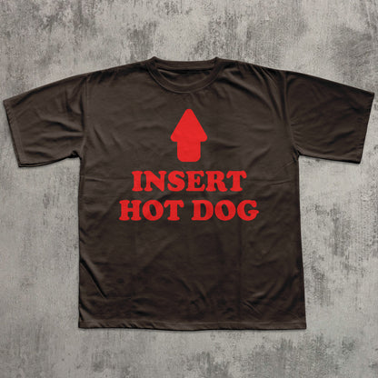 Brown t-shirt with red graphic and text 'INSERT HOT DOG' on a textured gray background