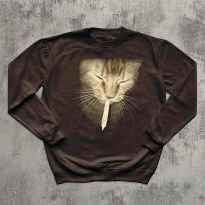 Brown sweatshirt with a cat graphic on a textured gray background
