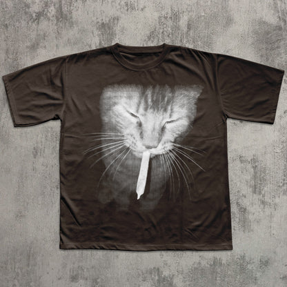 Brown t-shirt with a cat face design on a textured gray background