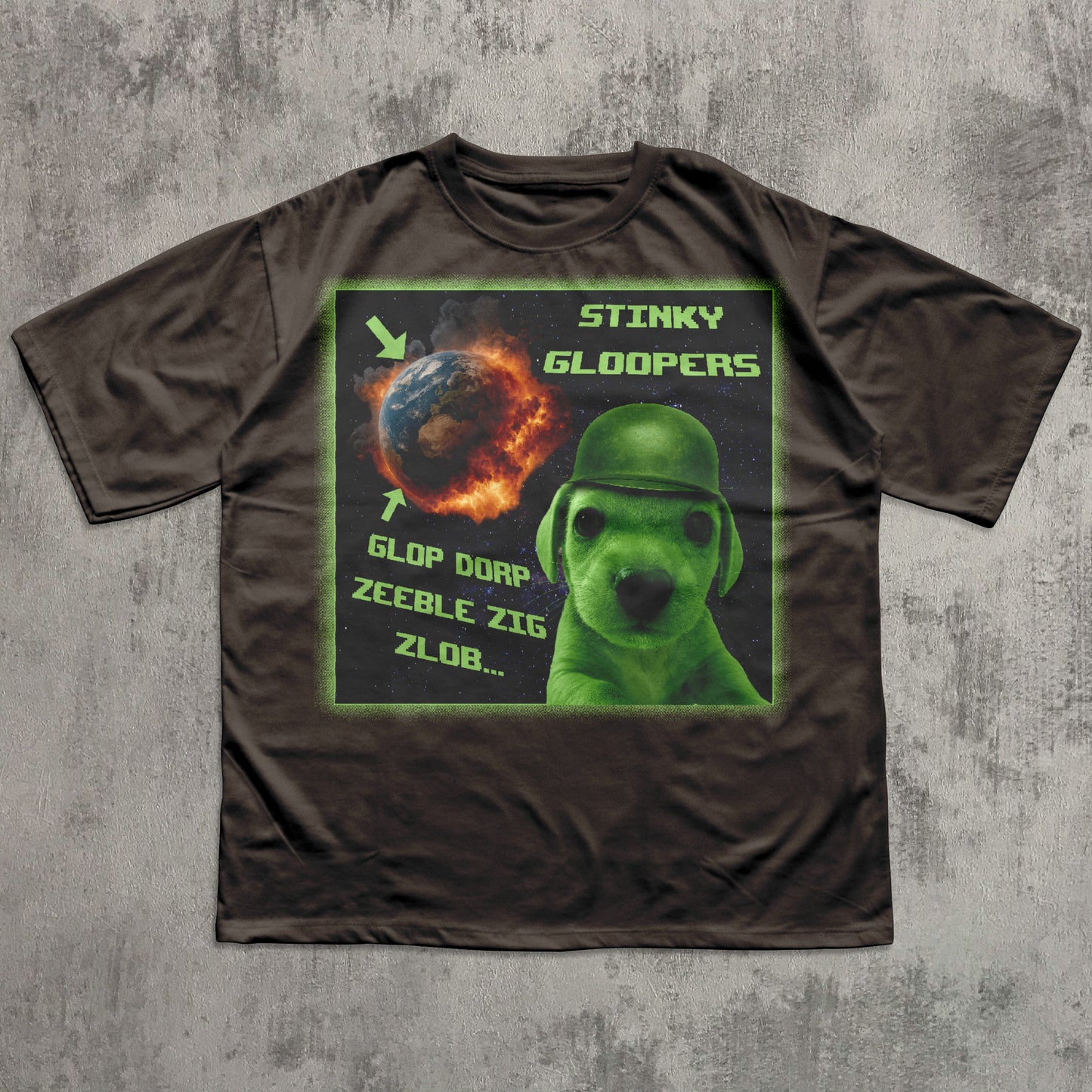Brown funny t-shirt with a graphic design featuring a green alien dog and text on a concrete surface