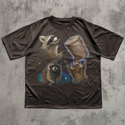 Brown funny t-shirt with raccoon design on a textured gray background