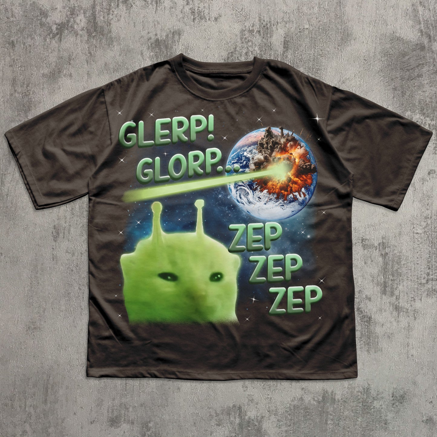 T-shirt with alien design and text on a gray surface