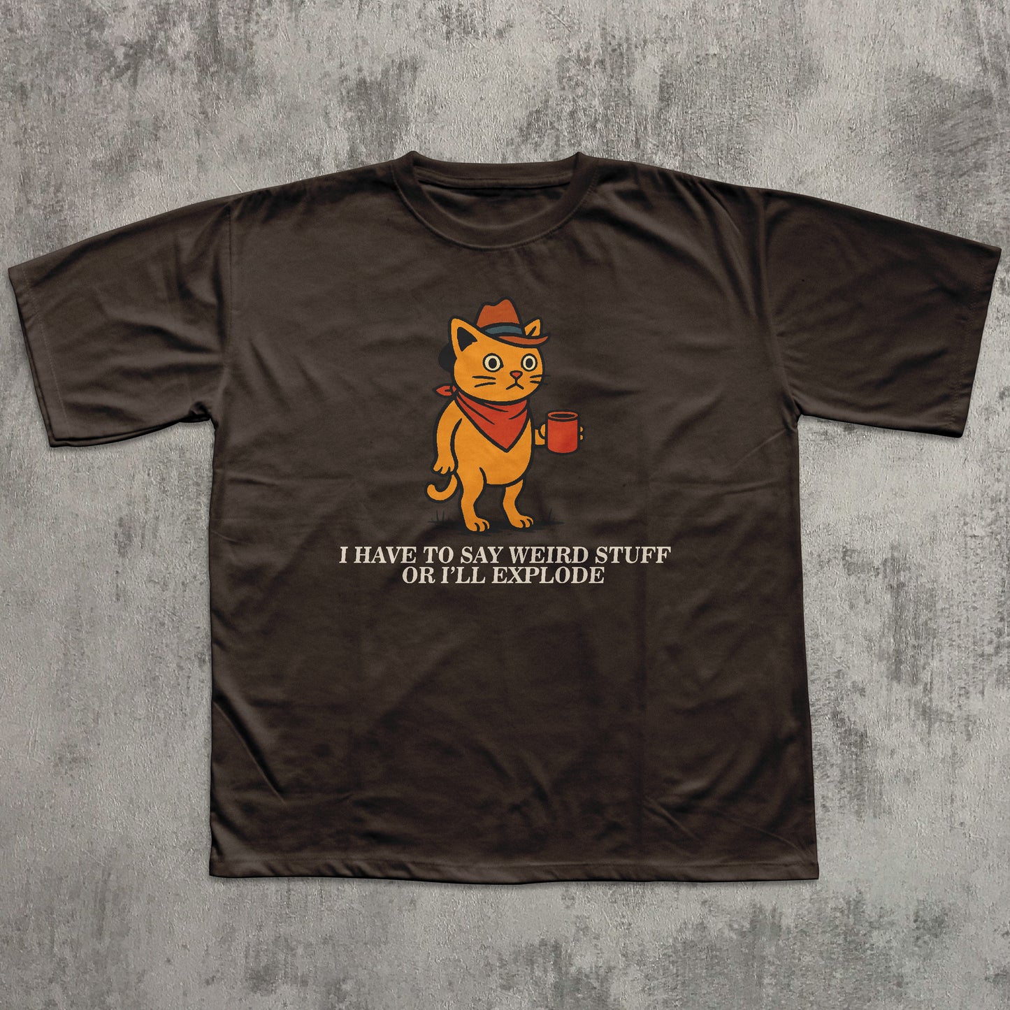 Brown t-shirt with a graphic of a cat holding a coffee cup and text on a textured gray background