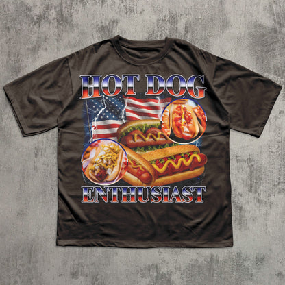 Brown t-shirt with hot dog graphic and 'Hot Dog Enthusiast' text on a textured gray background