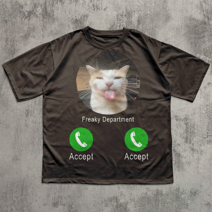 Brown t-shirt with a cat graphic and phone interface design on a textured gray background