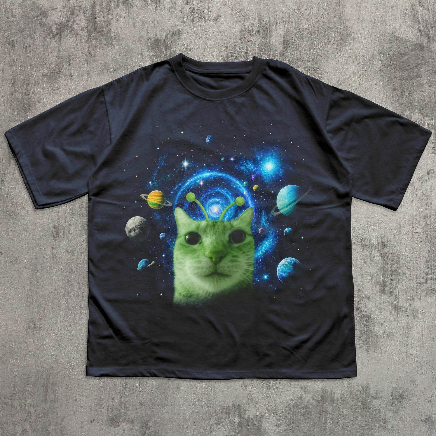 Black t-shirt with a green cat in space design on a textured gray background