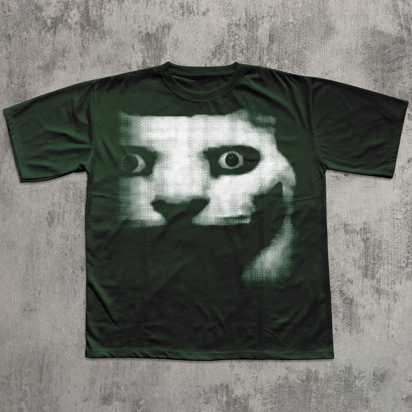 Green t-shirt with a graphic design on a textured gray background