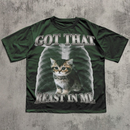 Green t-shirt with a cat graphic and text on a textured gray background