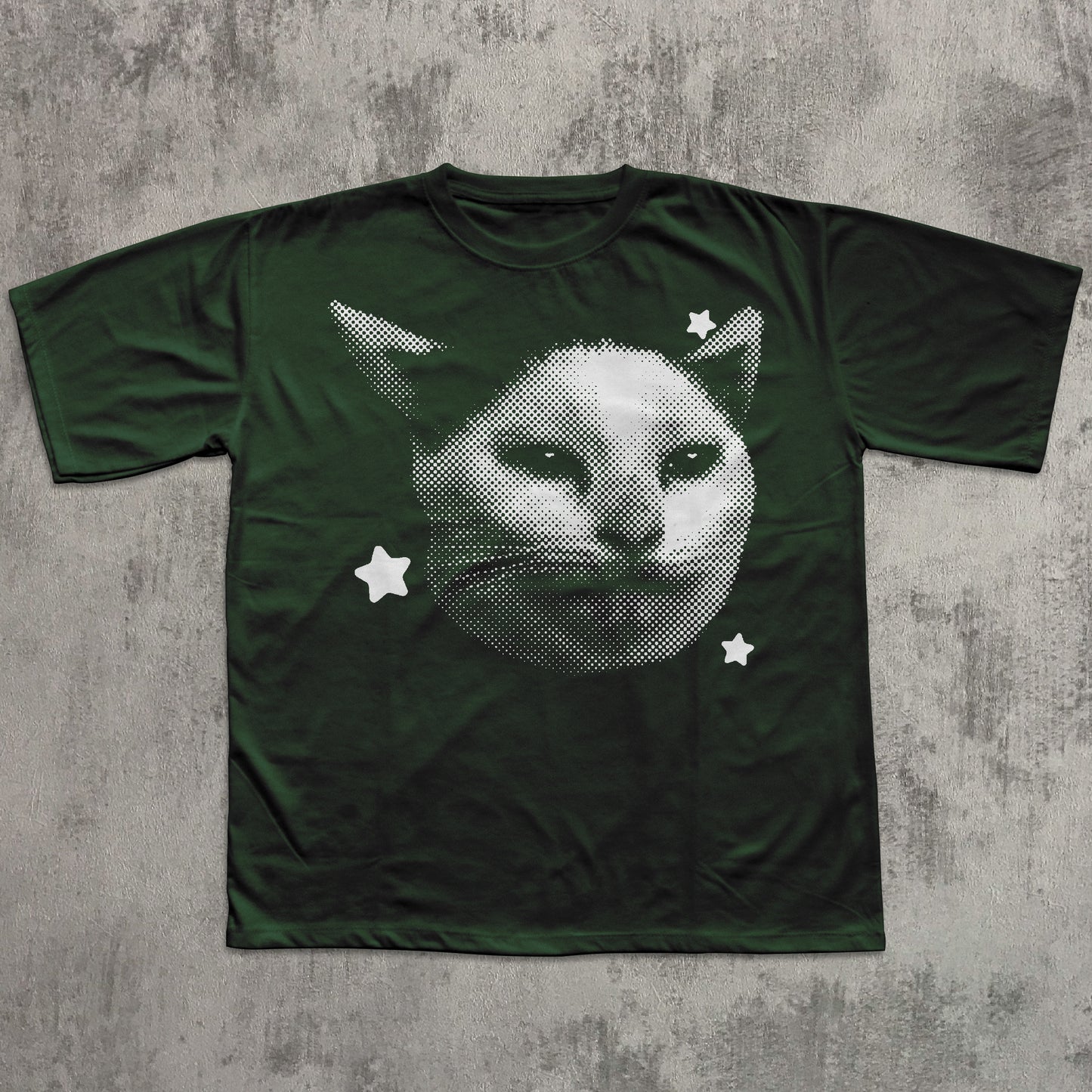 Green t-shirt with a cat graphic on a textured gray background