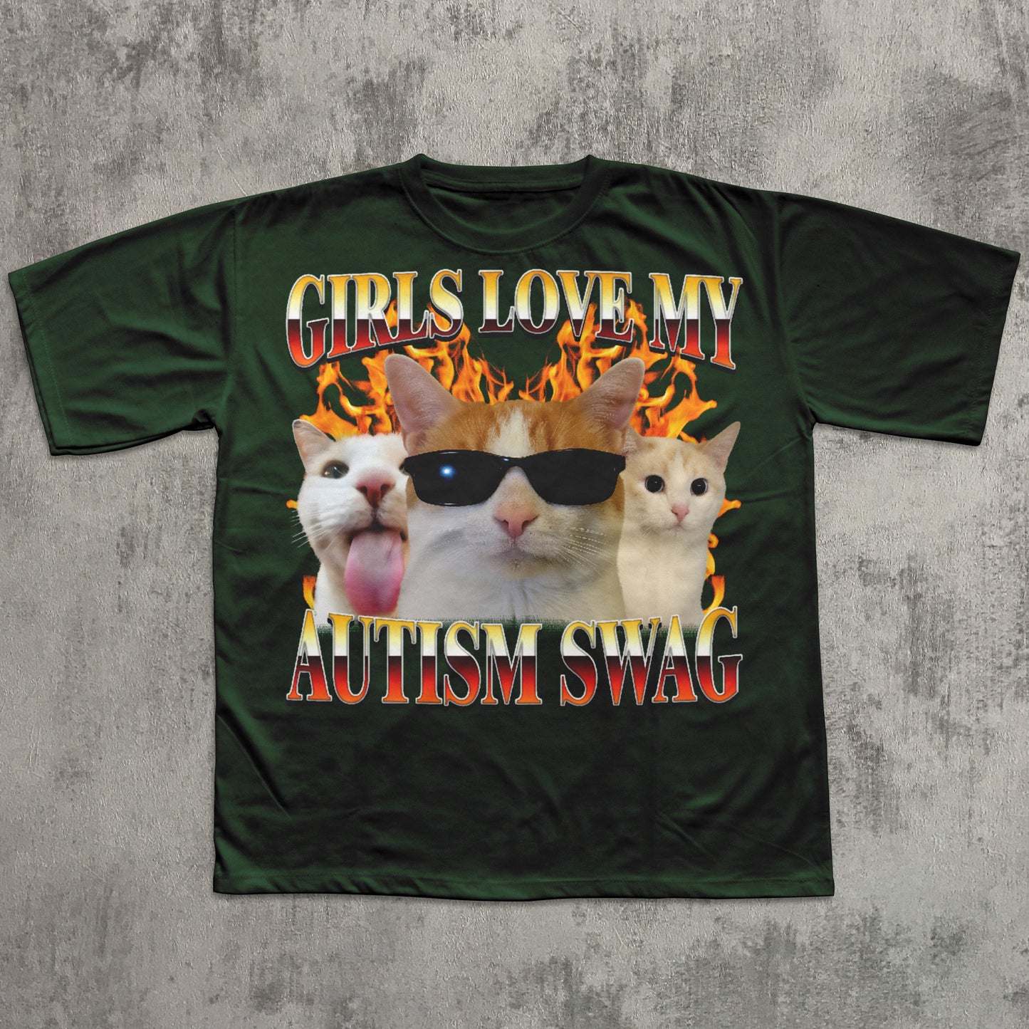 Green t-shirt with cat graphic and text 'Girls love my autism swag' on a concrete surface