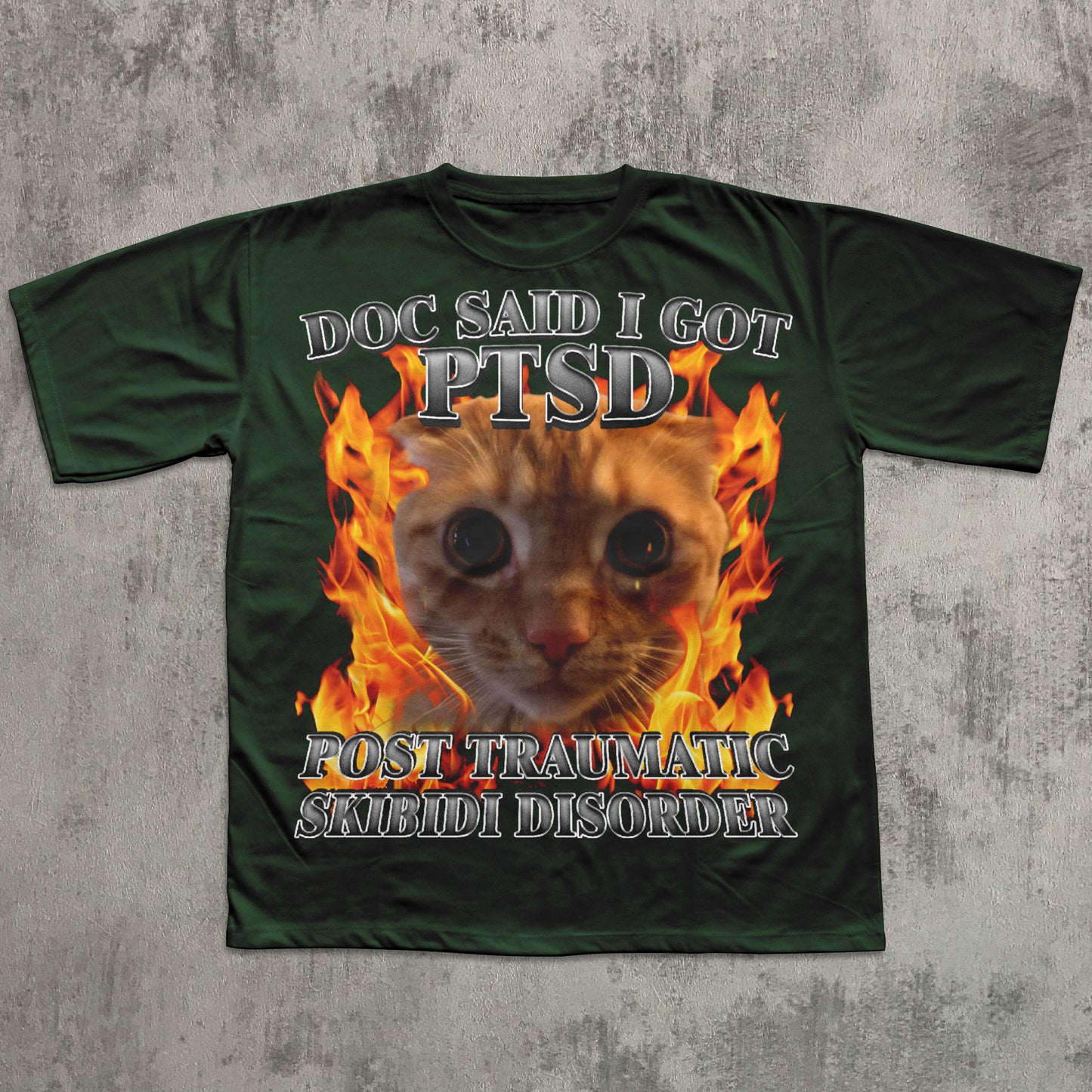 Green t-shirt with a cat graphic and text on a textured gray background