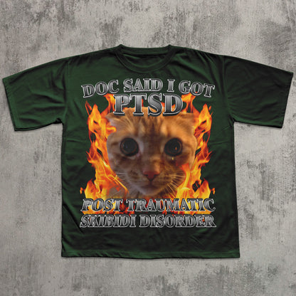 Green t-shirt with a cat graphic and text on a textured gray background