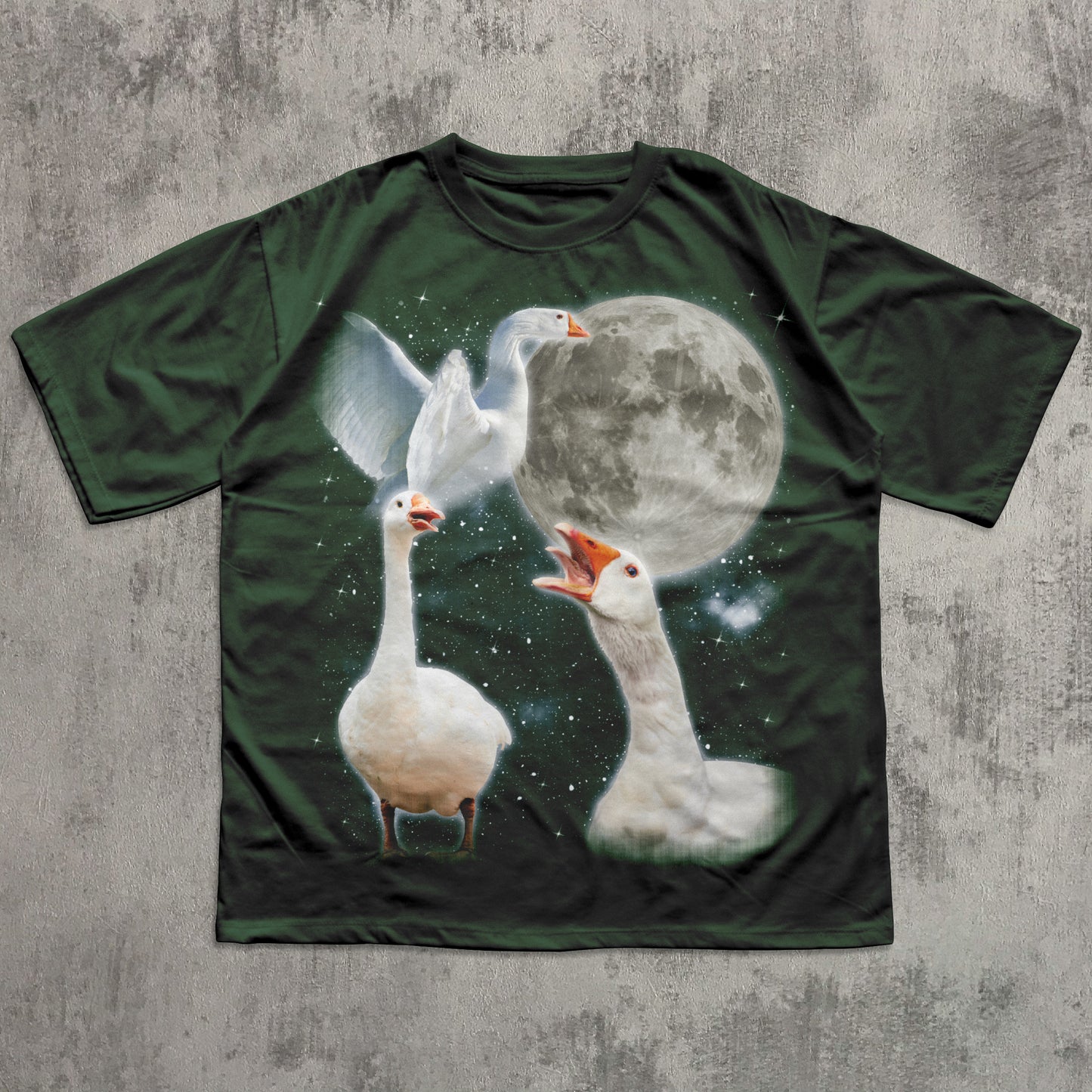 T-shirt with a design of three geese and a moon on a textured gray background