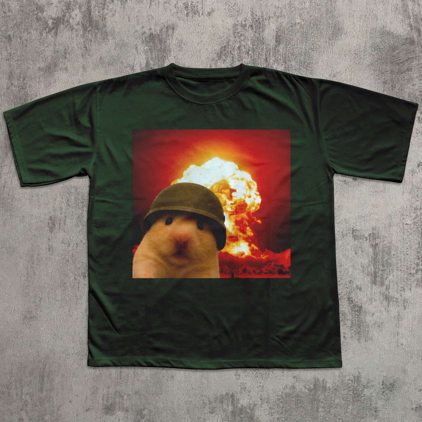 Green t-shirt with a graphic of a bear wearing a helmet and an explosion in the background on a textured gray surface.