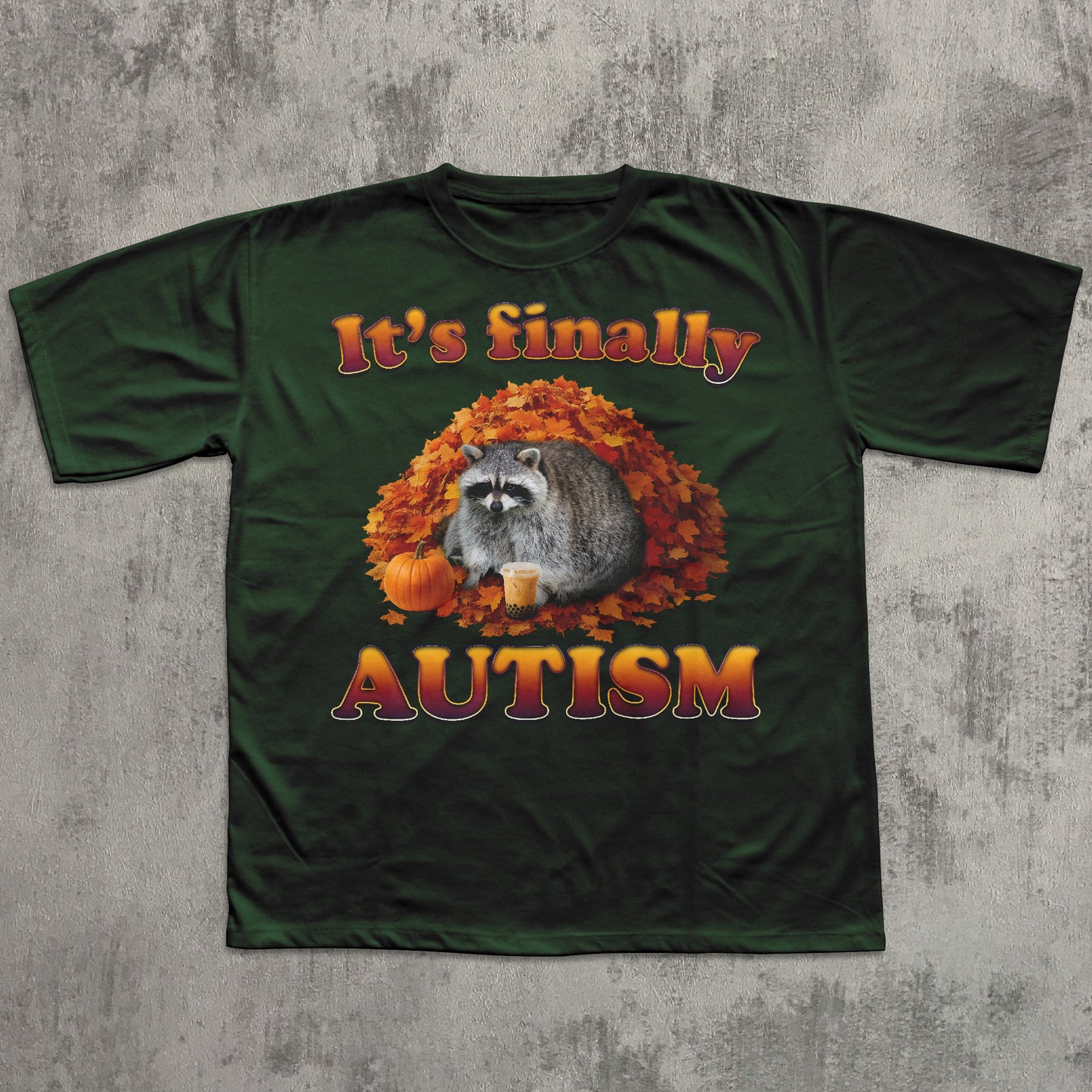 Green t-shirt with a raccoon and autumn leaves design on a textured gray background