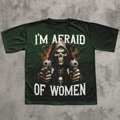 Green t-shirt with a graphic of a skeleton holding guns and text 'I'm Afraid of Women' on a textured gray background.