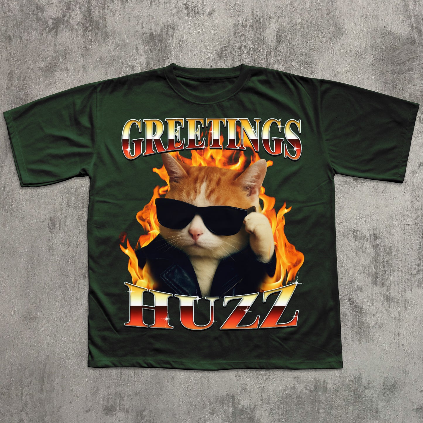 Green t-shirt with a cat graphic and 'Greetings HUZZ' text on a concrete background