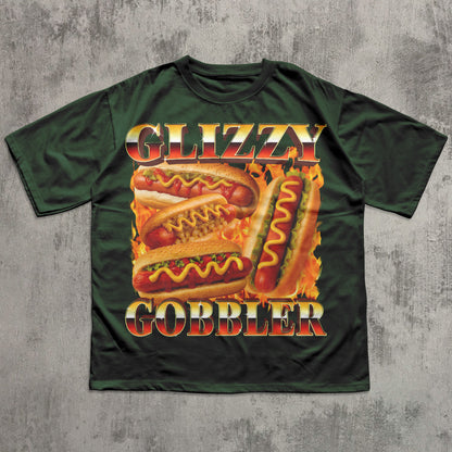 Green t-shirt with 'Glizzy Gobbler' hot dog graphic on a textured gray background