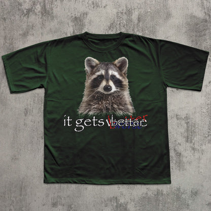 Green t-shirt with a raccoon graphic and text on a textured gray background