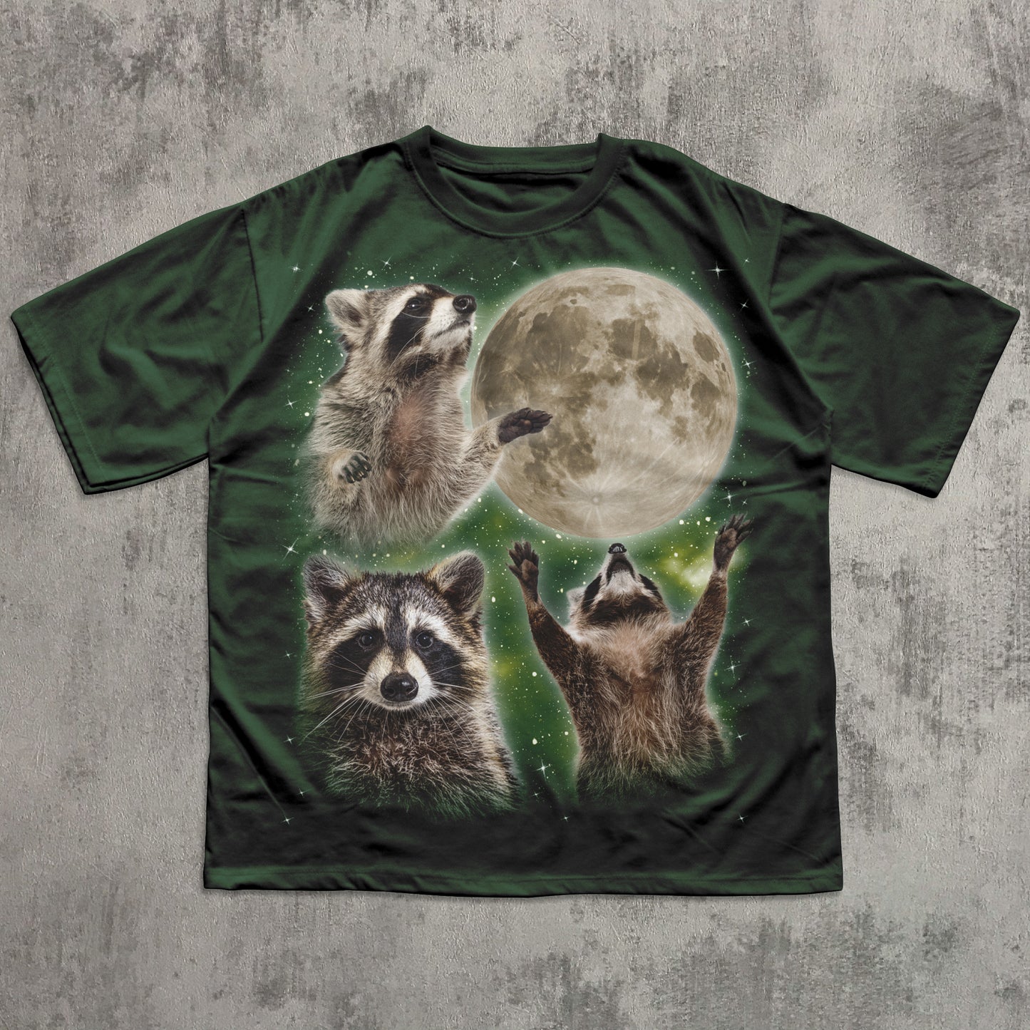 T-shirt with raccoon design and moon on a textured gray background