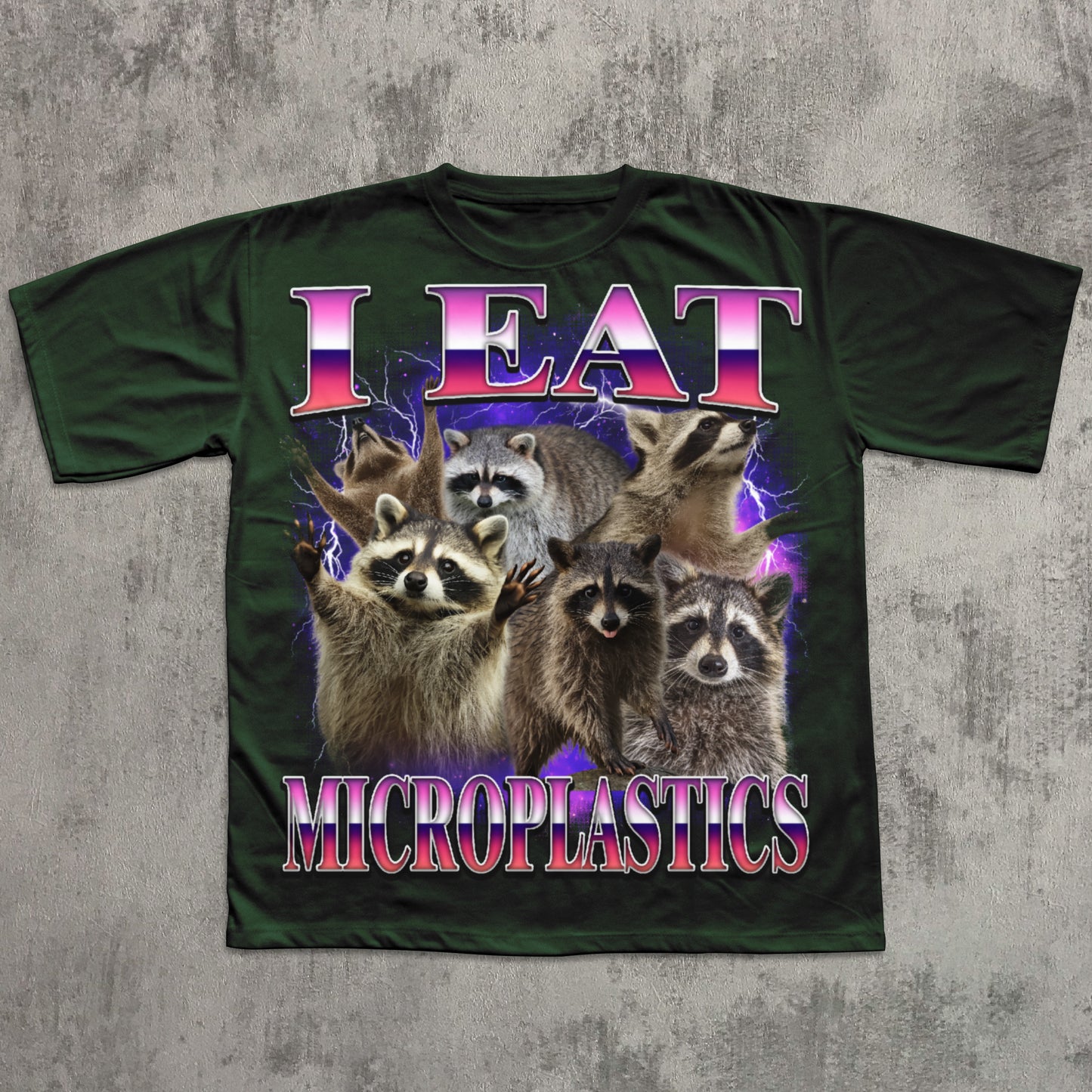 T-shirt with raccoons and text 'I Eat Microplastics' on a textured gray background