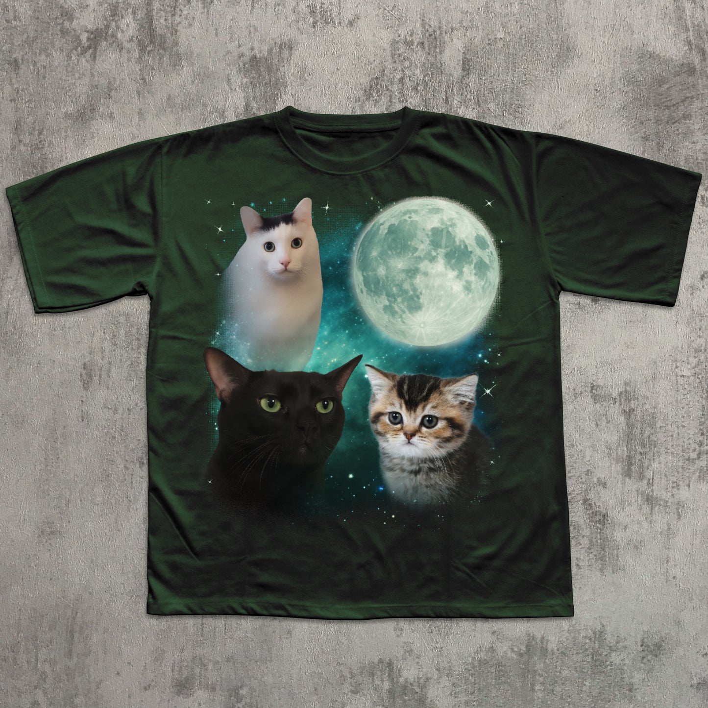 T-shirt with cats and a moon graphic on a textured surface