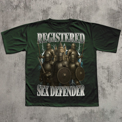 Green t-shirt with warrior graphic and text 'Registered Sex Defender' on a textured gray background