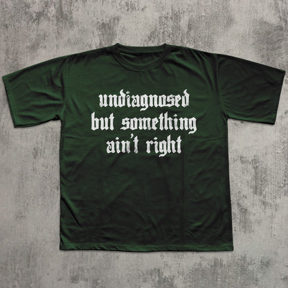 Green t-shirt with white text on a textured gray background