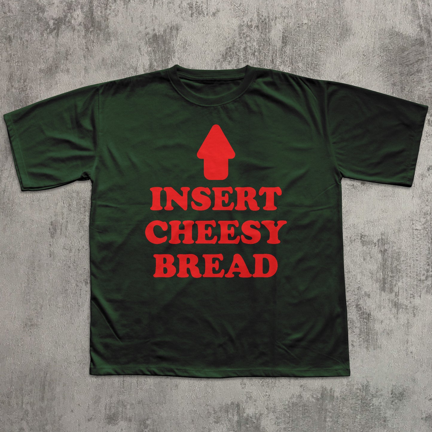 Green t-shirt with red text and graphic on a textured gray background