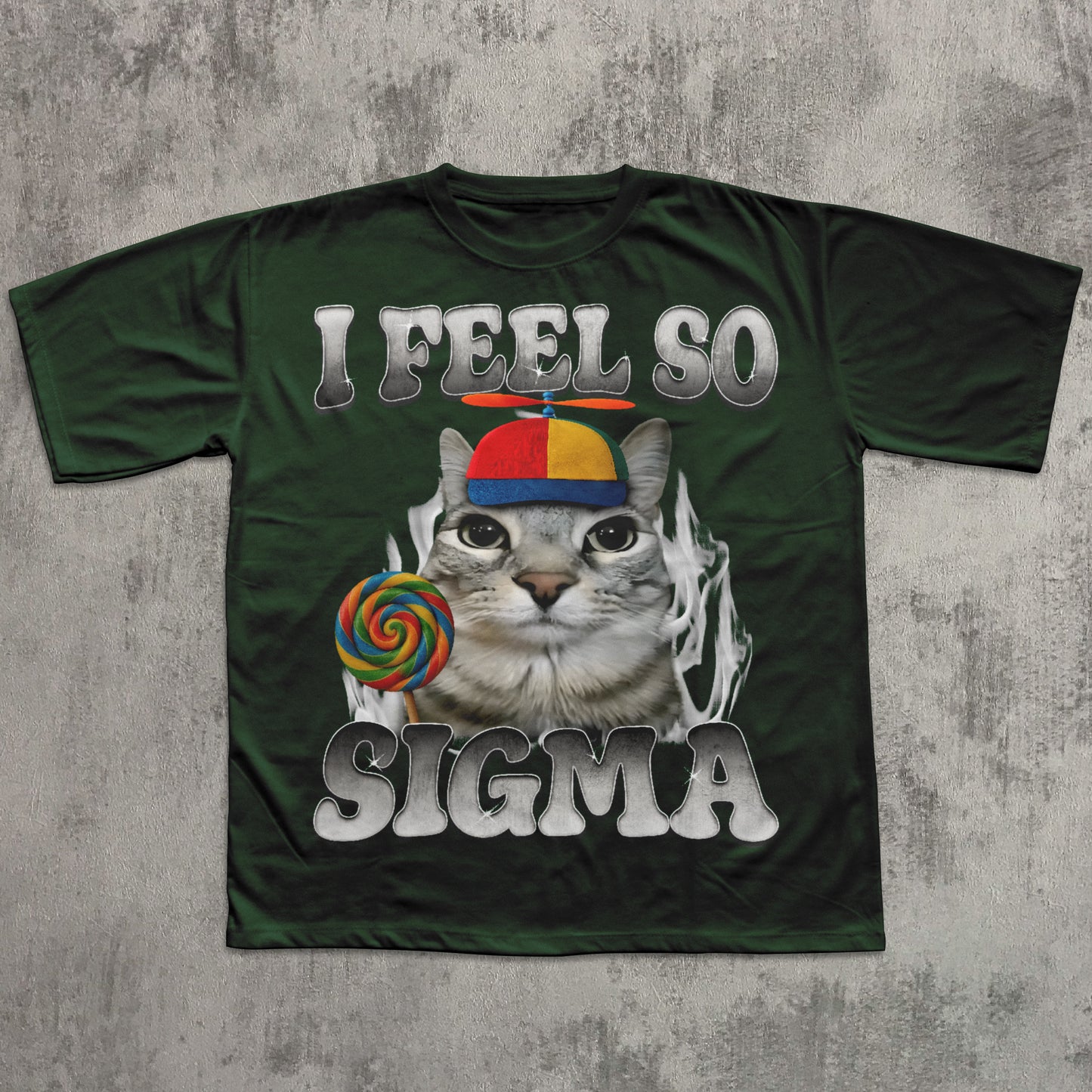 Green t-shirt with a cat graphic and text 'I Feel So Sigma' on a textured gray background
