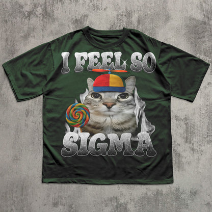 Green t-shirt with a cat graphic and text 'I Feel So Sigma' on a textured gray background