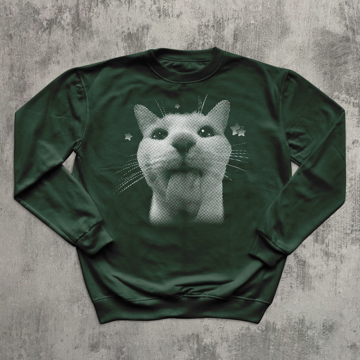 Green sweatshirt with a cat graphic on a textured gray background
