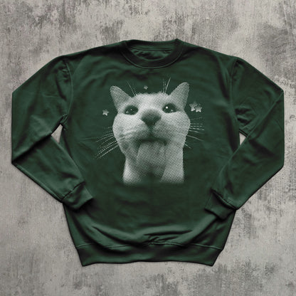 Green sweatshirt with a cat graphic on a textured gray background