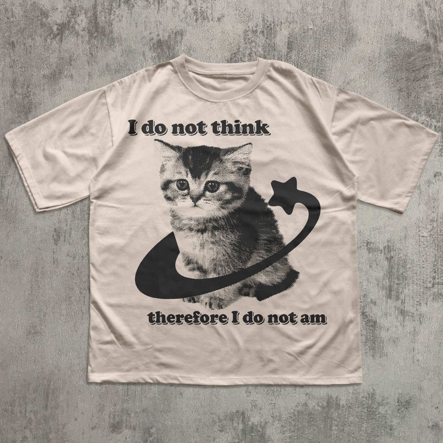 Beige t-shirt with a cat graphic and philosophical text on a textured gray background