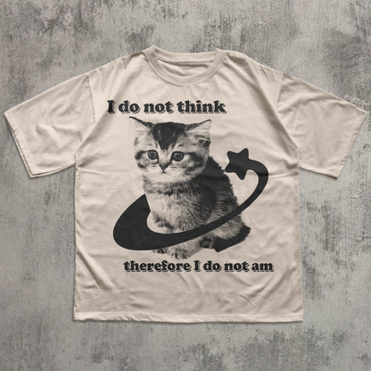 Beige t-shirt with a cat graphic and philosophical text on a textured gray background