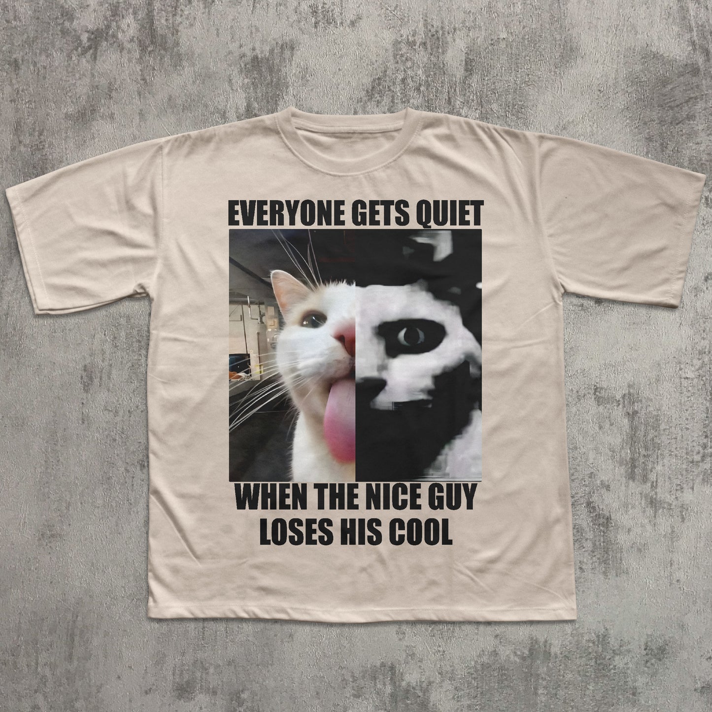 Beige t-shirt with a graphic of a cat and text on a textured gray background