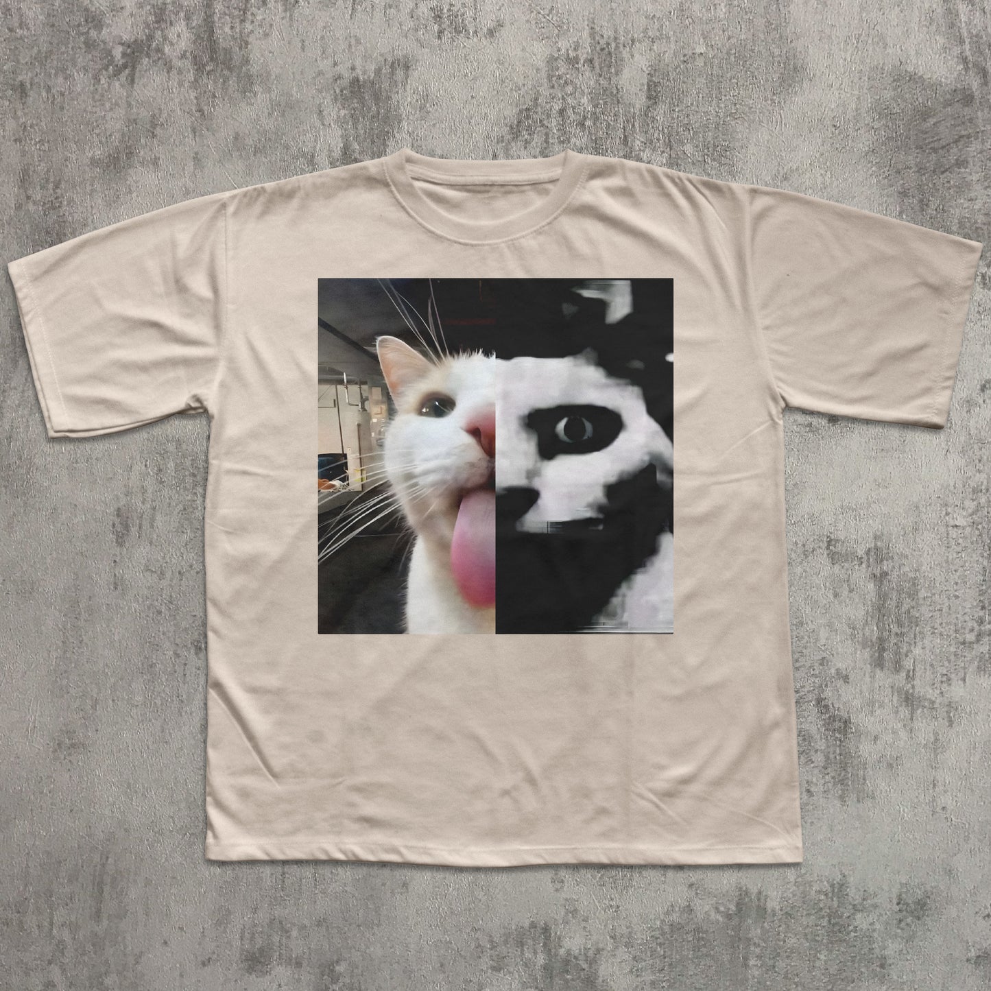 Beige t-shirt with a graphic of a cat's face on a textured gray background