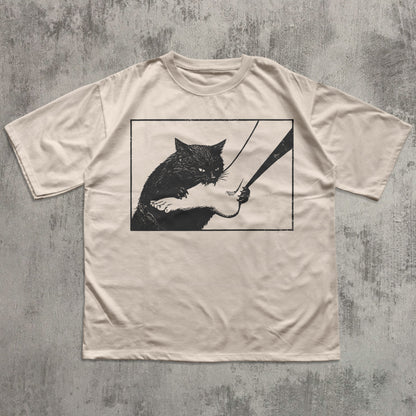 Funny black cat graphic t-shirt with mischievous cat illustration on ivory tee for cat lovers