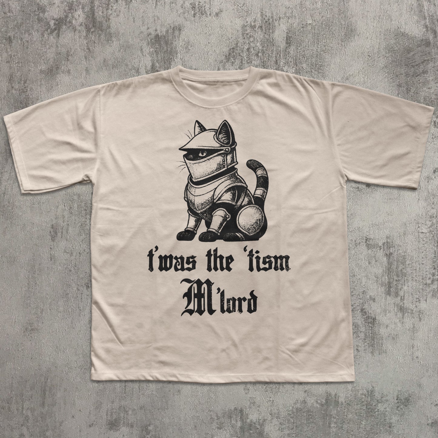 Beige t-shirt with a graphic of a cat in armor and text on a textured gray background