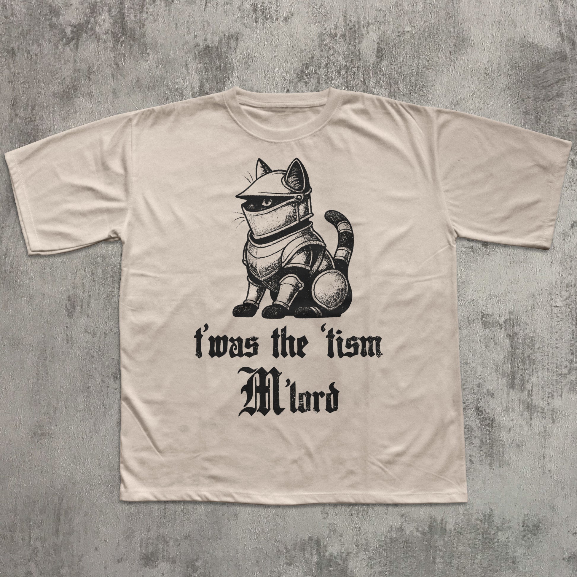 Beige t-shirt with a graphic of a cat in armor and text on a textured gray background