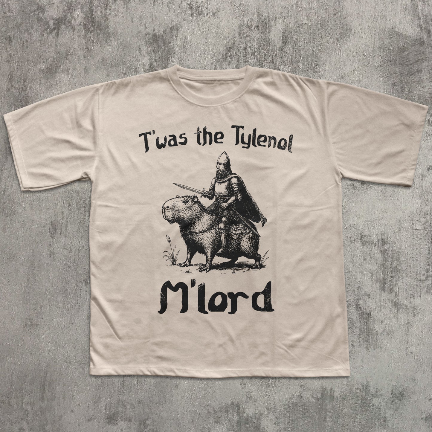 Beige t-shirt with graphic design and text on a textured gray background