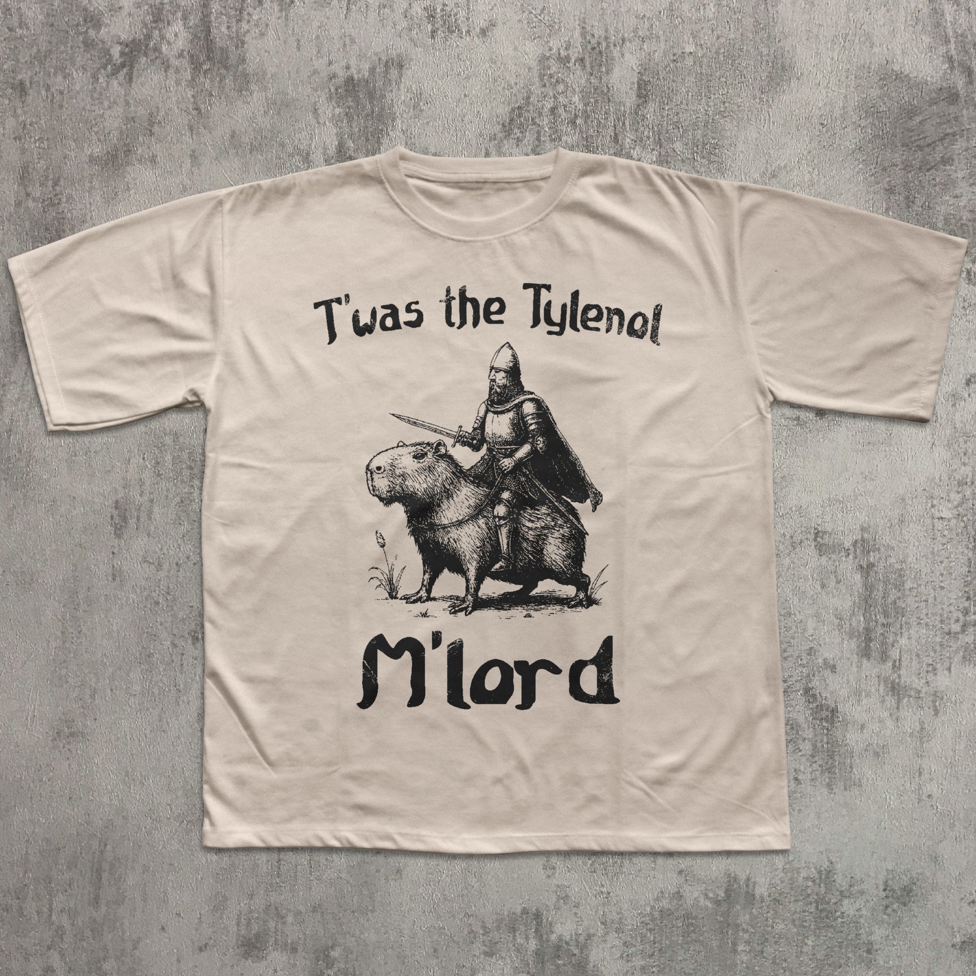 Beige t-shirt with graphic design and text on a textured gray background