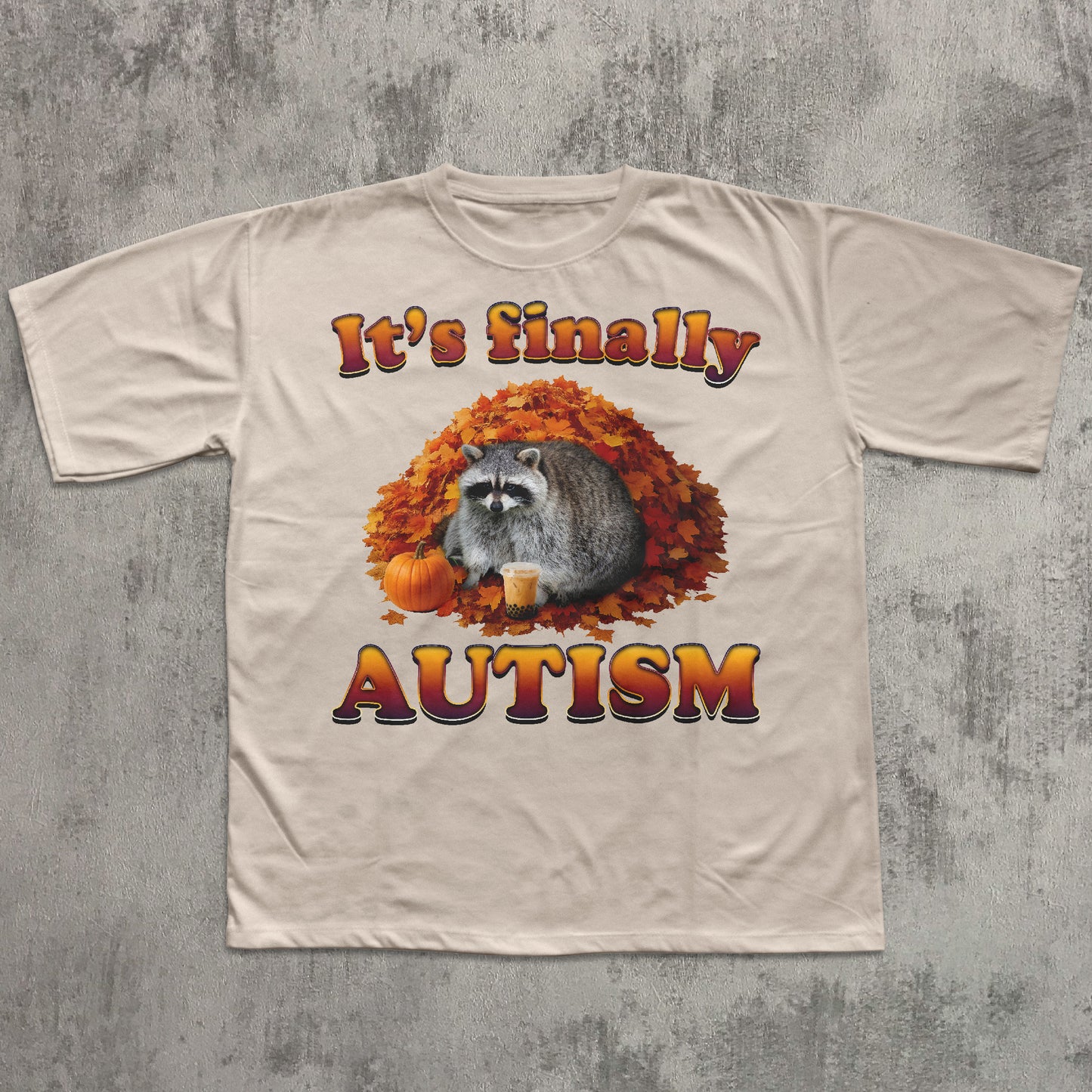 Beige t-shirt with raccoon and autumn design on a textured gray background