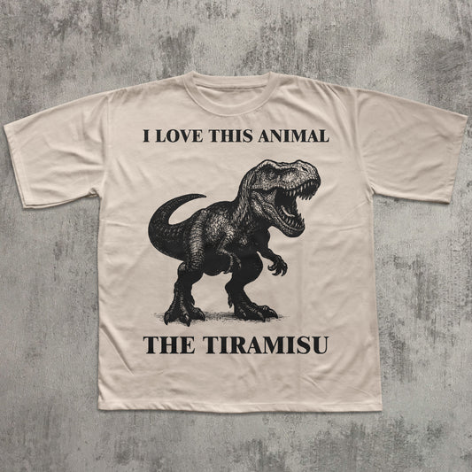 Beige t-shirt with a dinosaur graphic and text on a textured gray background