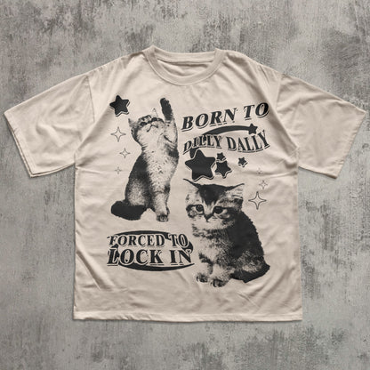 Beige t-shirt with black cat graphics and text on a textured gray background