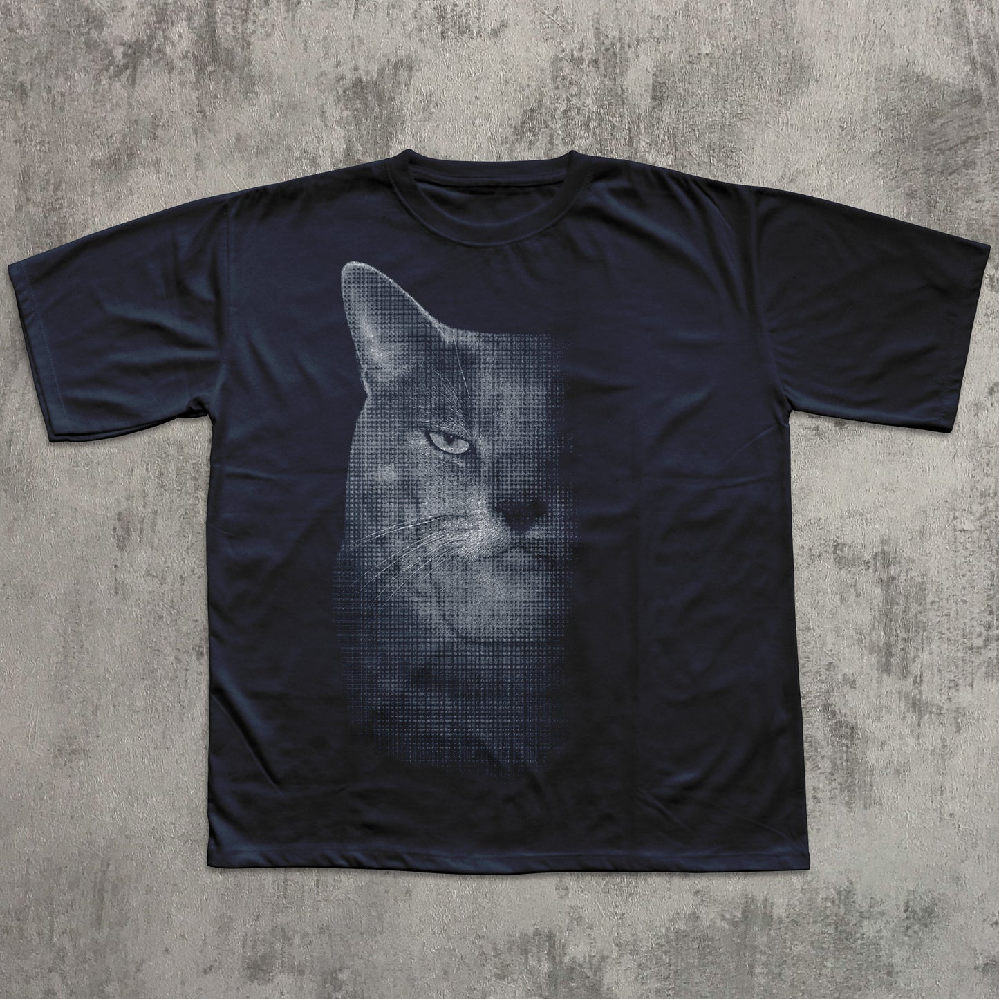 Black t-shirt with a cat graphic on a textured gray surface
