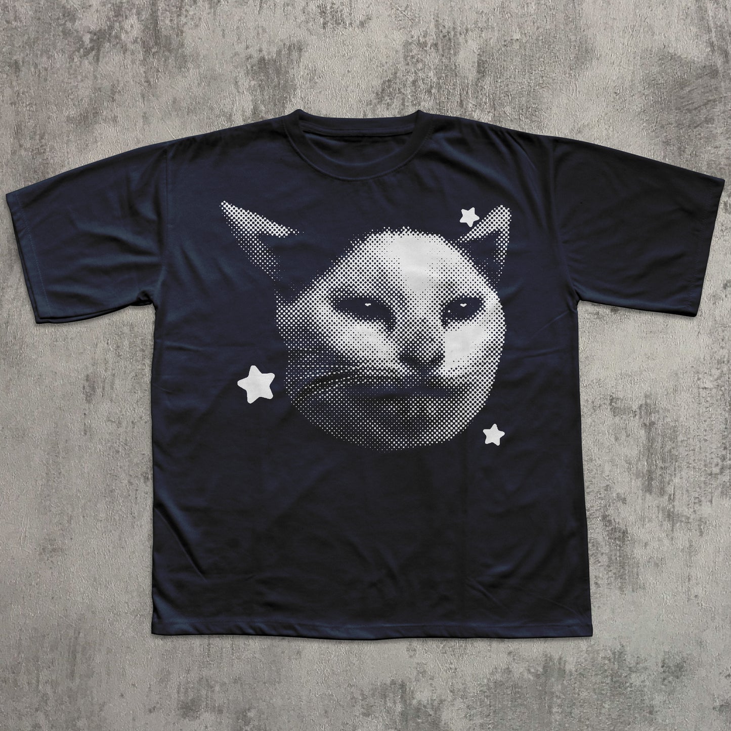 Black t-shirt with a white cat face design on a textured gray background