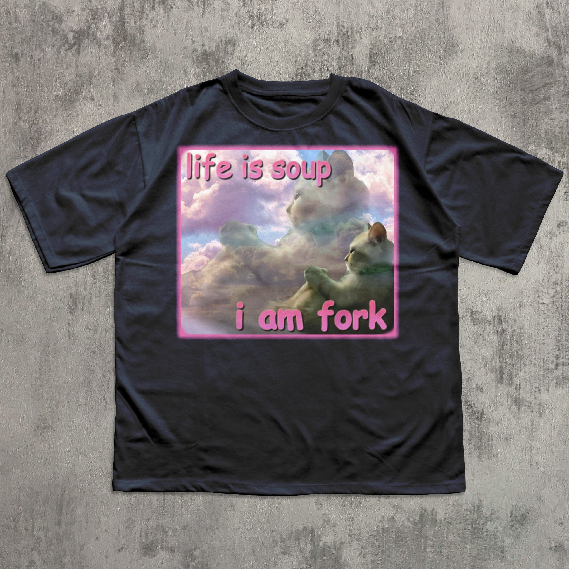 Black t-shirt with a graphic design and text on a textured gray background